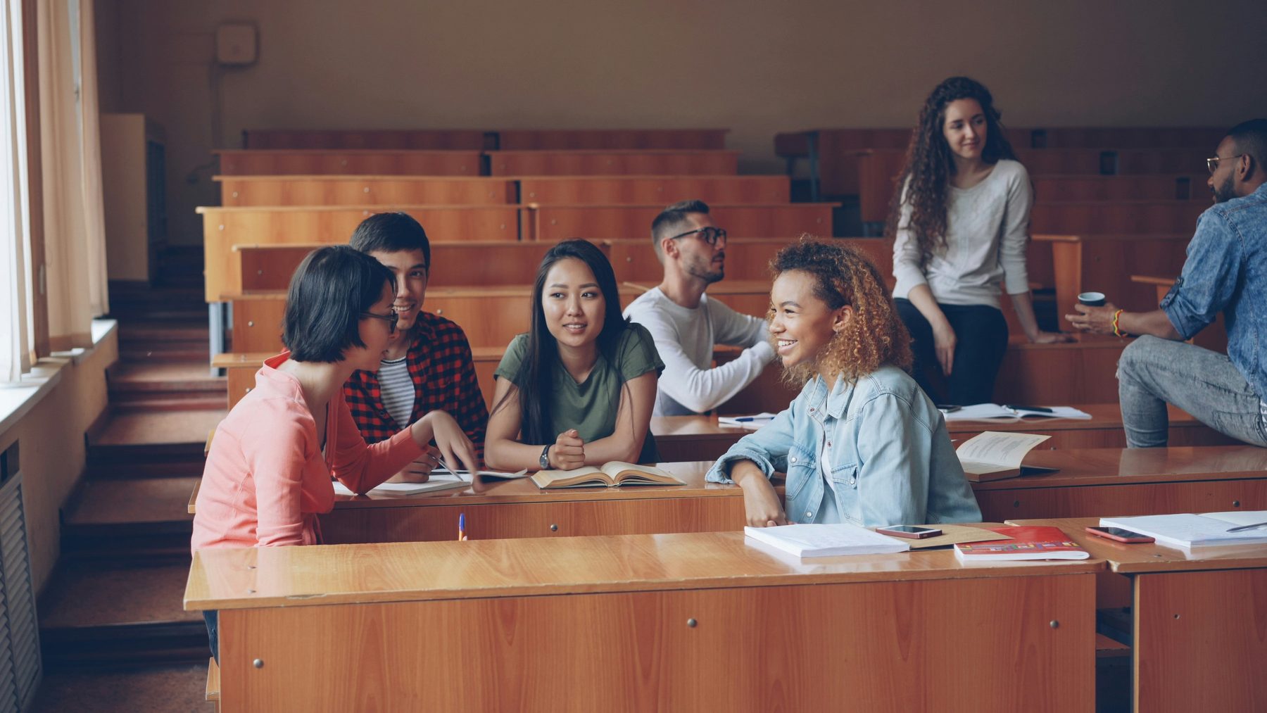 Students talking together in a university lecture hall