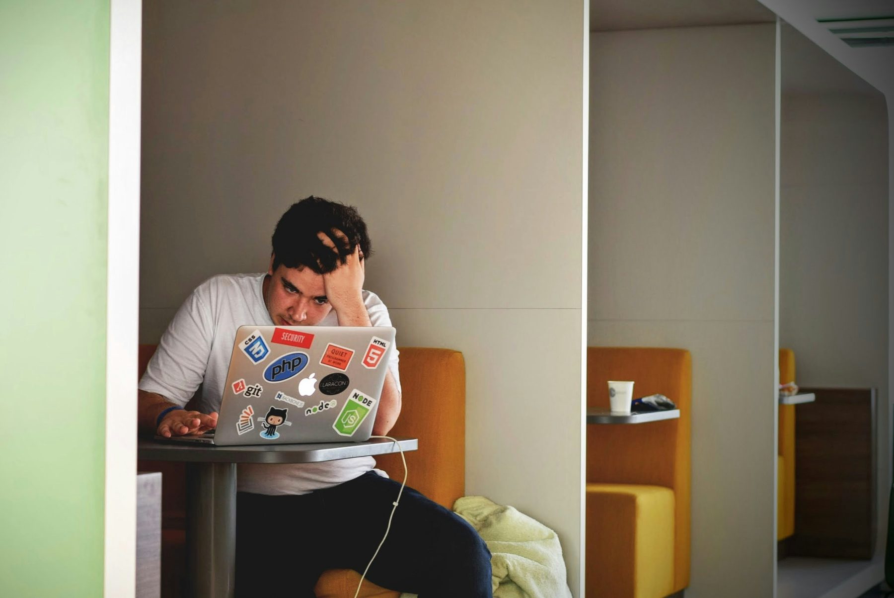 Student experiencing academic workload stress while using a laptop